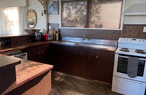 Ahipara House | Coastal Bach with Hot Outdoor Shower & Shipwreck Bay Surf & 90 Mile Beach Views