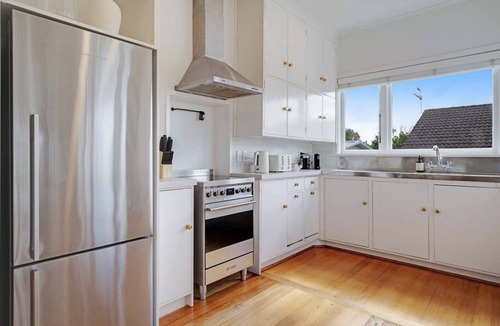Massey House | Massey East Haven | Sunlit Verandah and AC Comfort