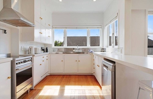 Massey House | Massey East Haven | Sunlit Verandah and AC Comfort