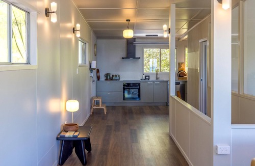 Onetangi House | Moana Beach House - Moana Beach House is a recently renovated two bedroom, two bathroom beach house set directly on the sand at Onetangi Beach. With a flat lawn leading straight onto the beach, it offers rare walk on beachfront access. The house feat