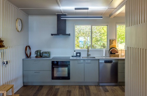 Onetangi House | Moana Beach House - Moana Beach House is a recently renovated two bedroom, two bathroom beach house set directly on the sand at Onetangi Beach. With a flat lawn leading straight onto the beach, it offers rare walk on beachfront access. The house feat