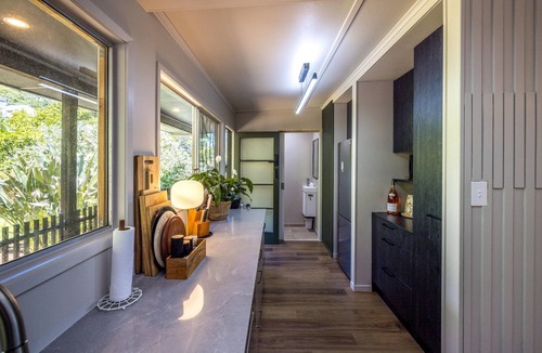 Onetangi House | Moana Beach House - Moana Beach House is a recently renovated two bedroom, two bathroom beach house set directly on the sand at Onetangi Beach. With a flat lawn leading straight onto the beach, it offers rare walk on beachfront access. The house feat