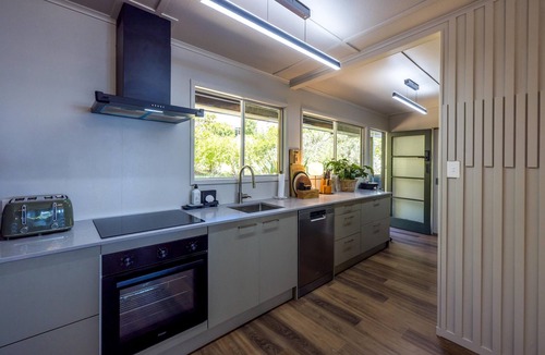 Onetangi House | Moana Beach House - Moana Beach House is a recently renovated two bedroom, two bathroom beach house set directly on the sand at Onetangi Beach. With a flat lawn leading straight onto the beach, it offers rare walk on beachfront access. The house feat