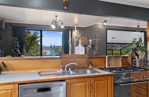 Okere Falls House | ŌKERE Ridge - Stone, native timber and tree ferns overlooking Lake Rotoiti