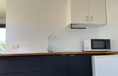 Pukehina House | Pukehina beach house: Estuary views + Outdoor bath