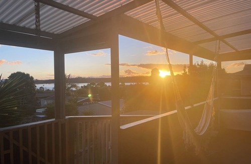 Pukehina House | Pukehina beach house: Estuary views + Outdoor bath