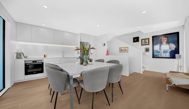 A light-filled Ponsonby townhouse. Open-plan living opens to a sheltered balcony, with a restful queen bedroom and a separate TV lounge to retreat to. Step outside and you're spoilt for choice: Ponsonby Road's cafés, shops and restaurants. in Ponsonby