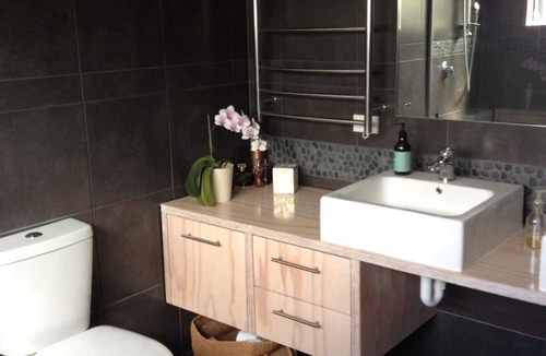 Raglan House | Okete Landing - Lifestyle retreat on Raglan harbour with grass tennis court.