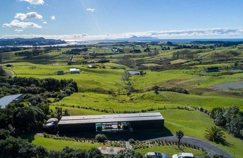 Mangawhai House | The Glass House - Modern, pet-friendly designer holiday home with spectacular views and spa pool
