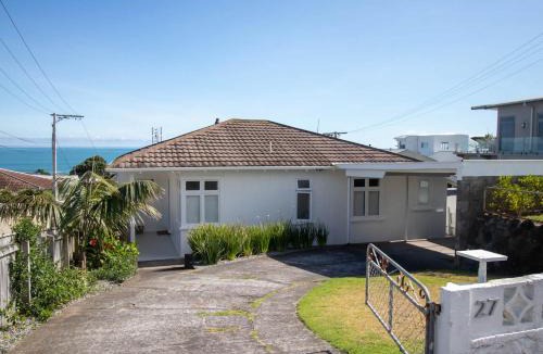 Rewa House | Blue Water Cottage - with beachfront coastal views