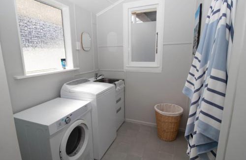 Rewa House | Blue Water Cottage - with beachfront coastal views