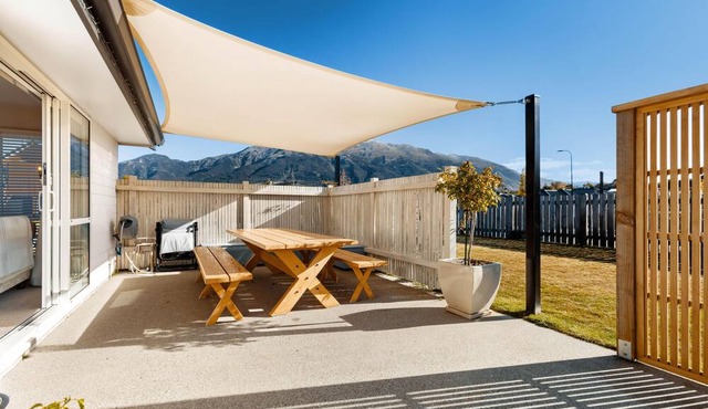 Home nestled in Hawea - A four-bedroom Hawea home with mountain views. Enjoy a modern kitchen, spacious living areas, two bathrooms, and a cosy fireplace in Lake Hawea