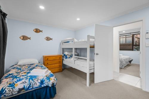 Waterfront location with estuary outlook and ocean beach access - sleeps 19